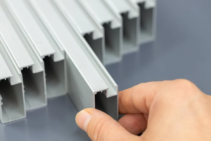 A person’s hand holding a component that can be made with plastic sheet extrusion.