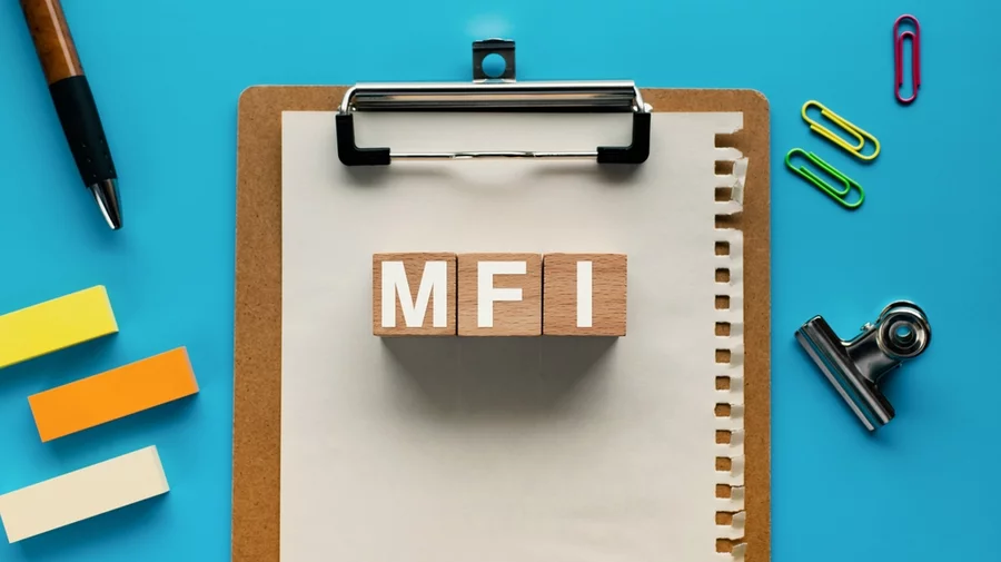 The letters “MFI” (Melt Flow Index) as blocks on a clipboard